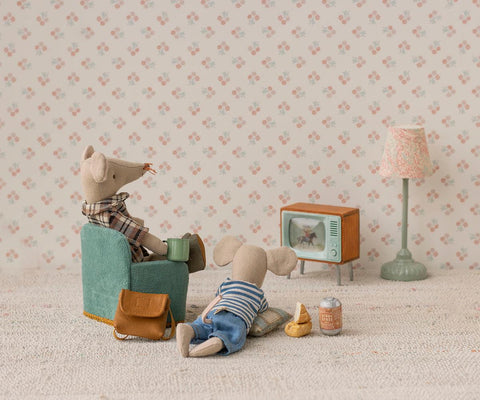 Small wooden television with mint-green casing among seated mouse toys
