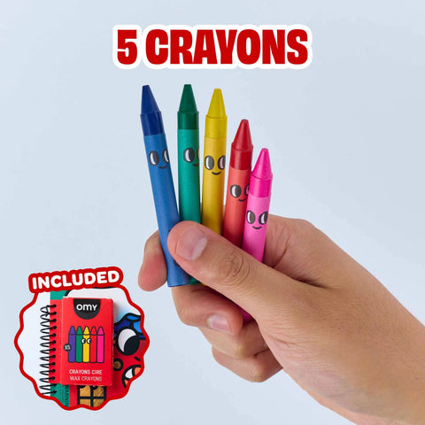 Hand holding five wax crayons above a small coloring book cover