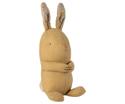 Seated yellow bunny plush with long patterned ears and folded arms