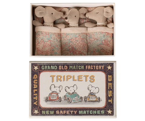 Three soft baby mice tucked into patterned matchbox bedding beneath a vintage-style label.