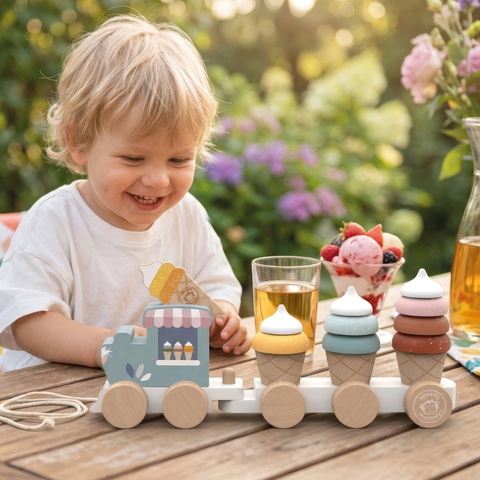 Ice cream train stacking toy on table beside child, with wooden wheels