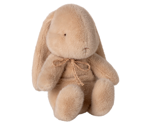 Small latte-colored plush bunny with floppy ears and a braided neck bow.