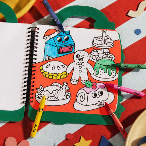 Open Christmas coloring and stickers book page with cartoon characters and crayons